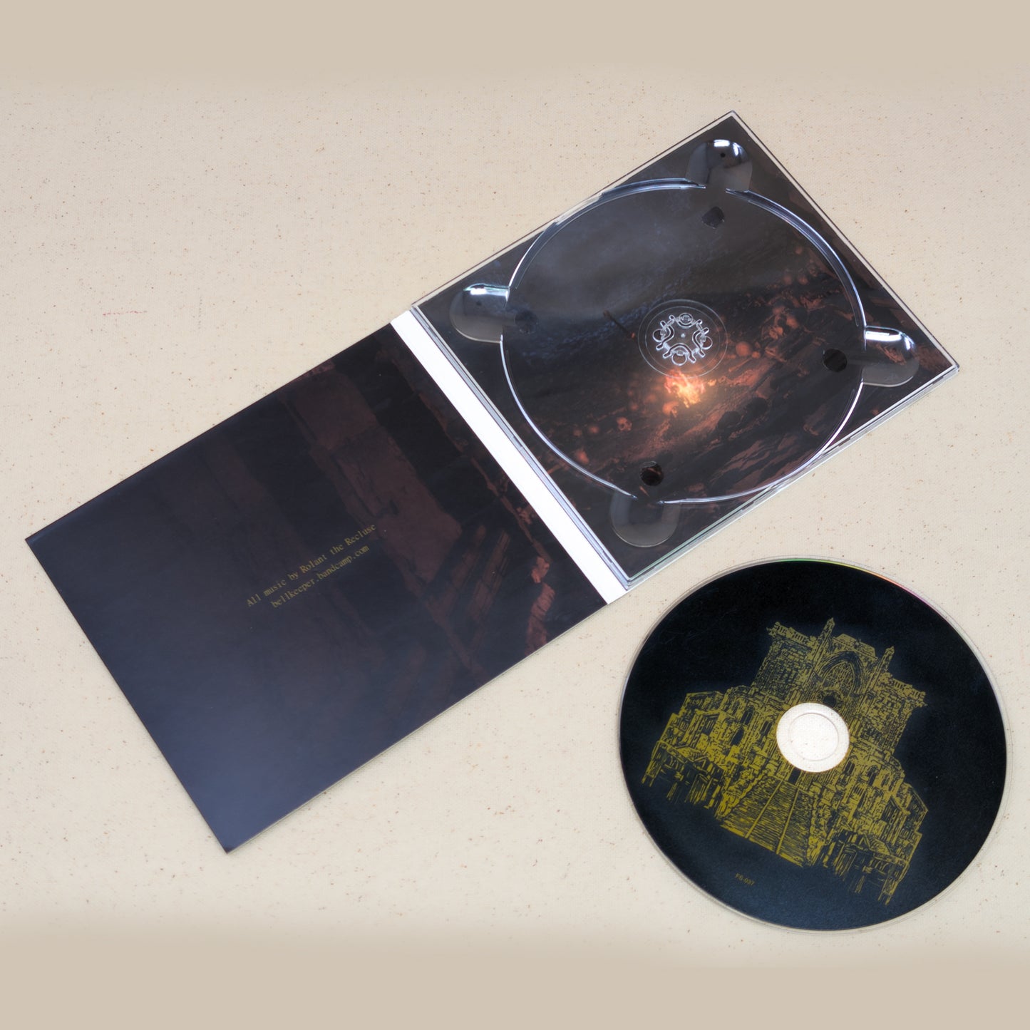 CD of Bellkeeper's First Flame of Lordran sitting next to the CD case with graphics of a sword in a fire.