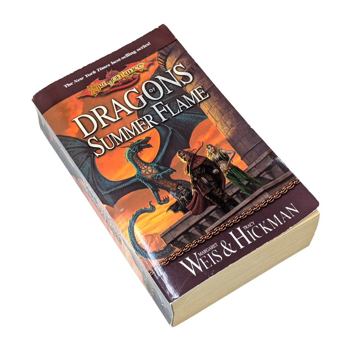 paperback book with a dragon and two fantasy warriors on the cover with the title Dragons of Summer Flame