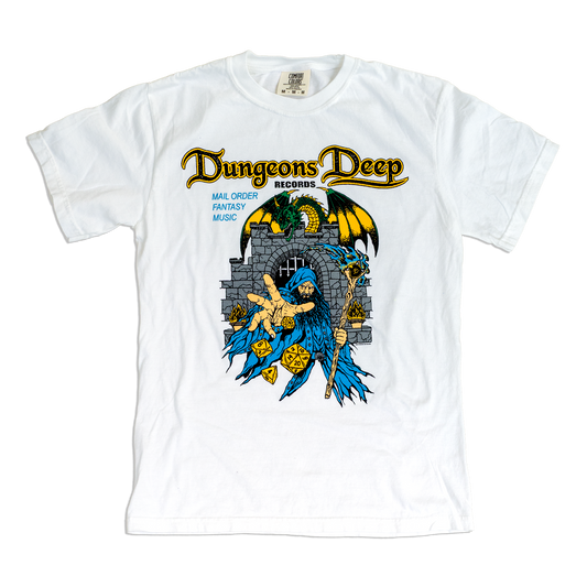 A white short-sleeve t-shirt with a graphic print for 'Dungeons Deep Records', featuring a blue-robed fantasy character, a gray stone tower, and a green dragon, displayed flat against a white background.