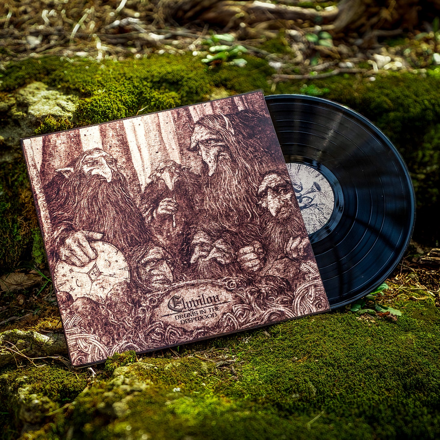 Vinyl record with cover featuring engraved images of dwarves on a natural background. The vinyl is black and perched on a bed of moss.