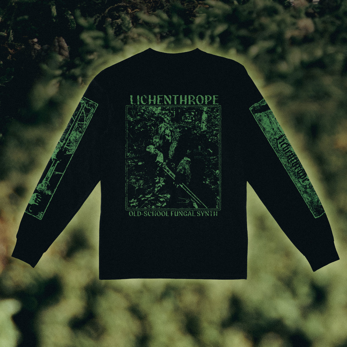 Black long-sleeve t-shirt with green graphic prints on the back and sleeves, featuring the text 'LICHENTHROPE' and 'OLD SCHOOL FUNGAL SYNTH', displayed against a blurred forest background.