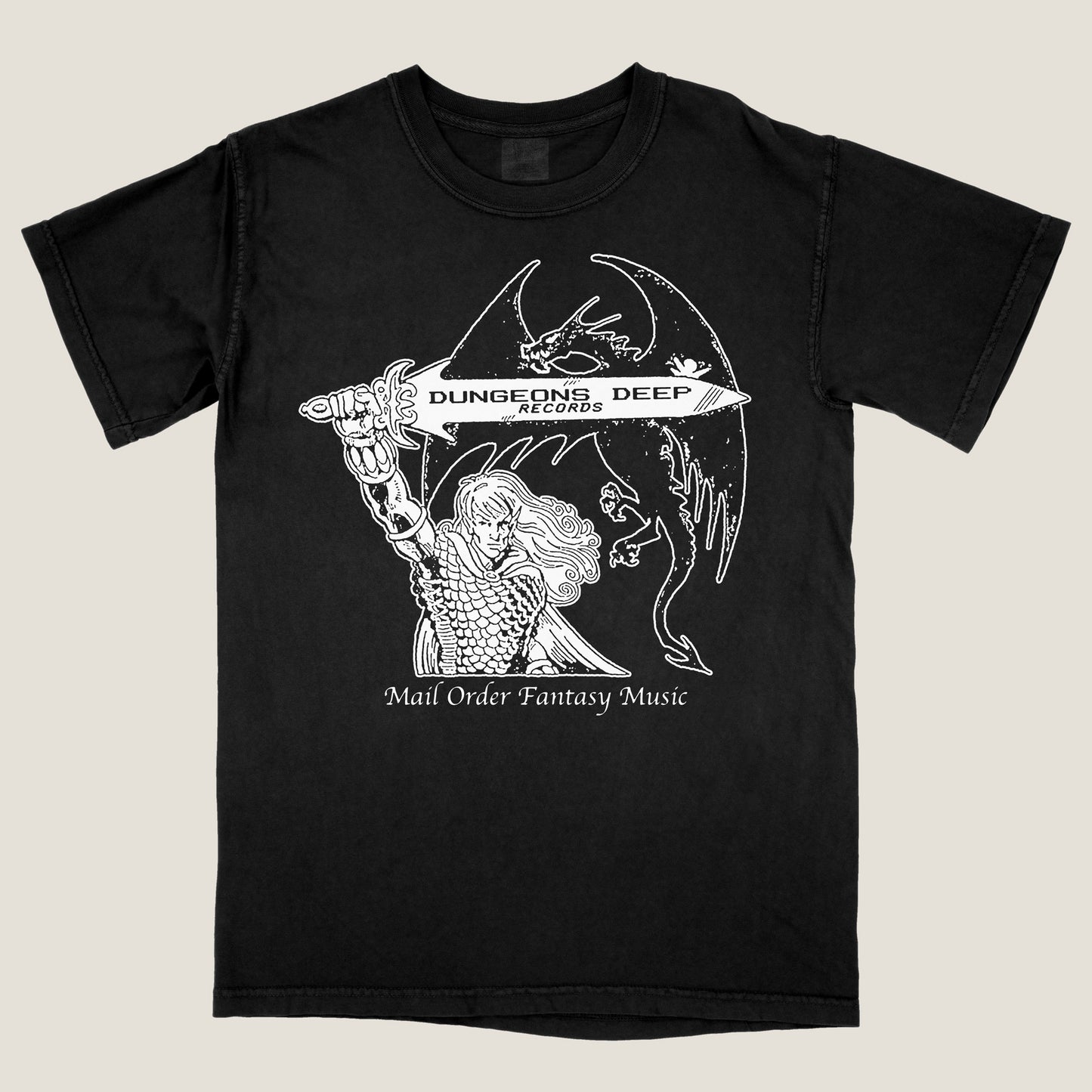 Black Comfort Colors t-shirt with 'Mail Order Fantasy Music' text and illustrations screen printed on the front. The design depicts a man holding a sword with the words "Dungeons Deep Records" inscribed next to a fantasy dragon.