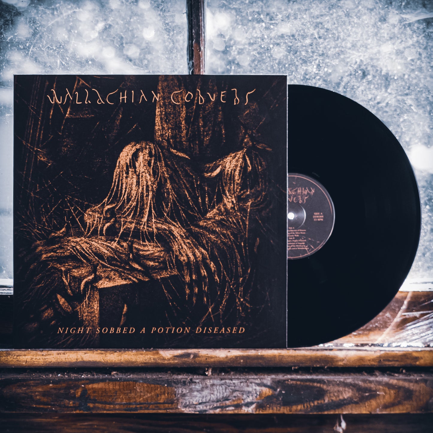 Black Vinyl record of Wallachian Cobwebs Night Sobbed a Potion Diseased featuring brown artwork of a mummified being. Set against a cobwebbed scenery.