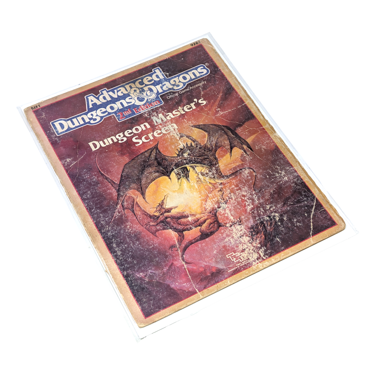 A vintage Dungeons & Dragons Dungeon Masters Screen with two dragons battling on the cover in distressed condition