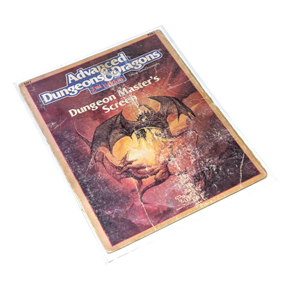 A vintage Dungeons & Dragons Dungeon Masters Screen with two dragons battling on the cover in distressed condition