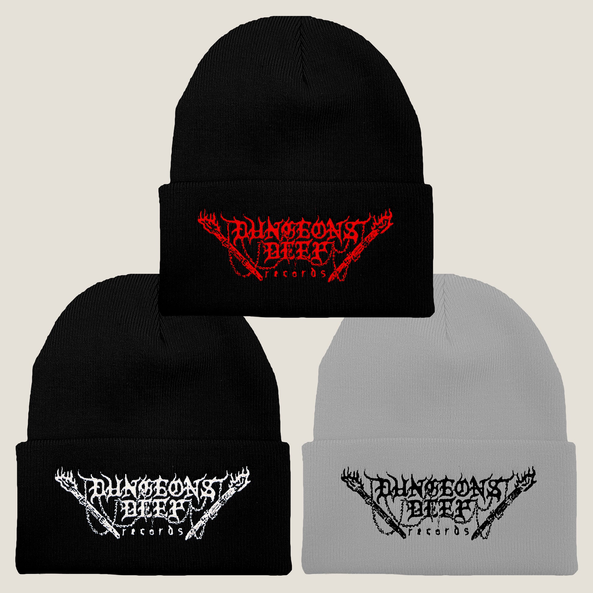 Three Dungeons Deep Records logo beanies in different colors: black with red stitching, gray with black stitching, and black with white stitching, all featuring an embroidered logo on the front.