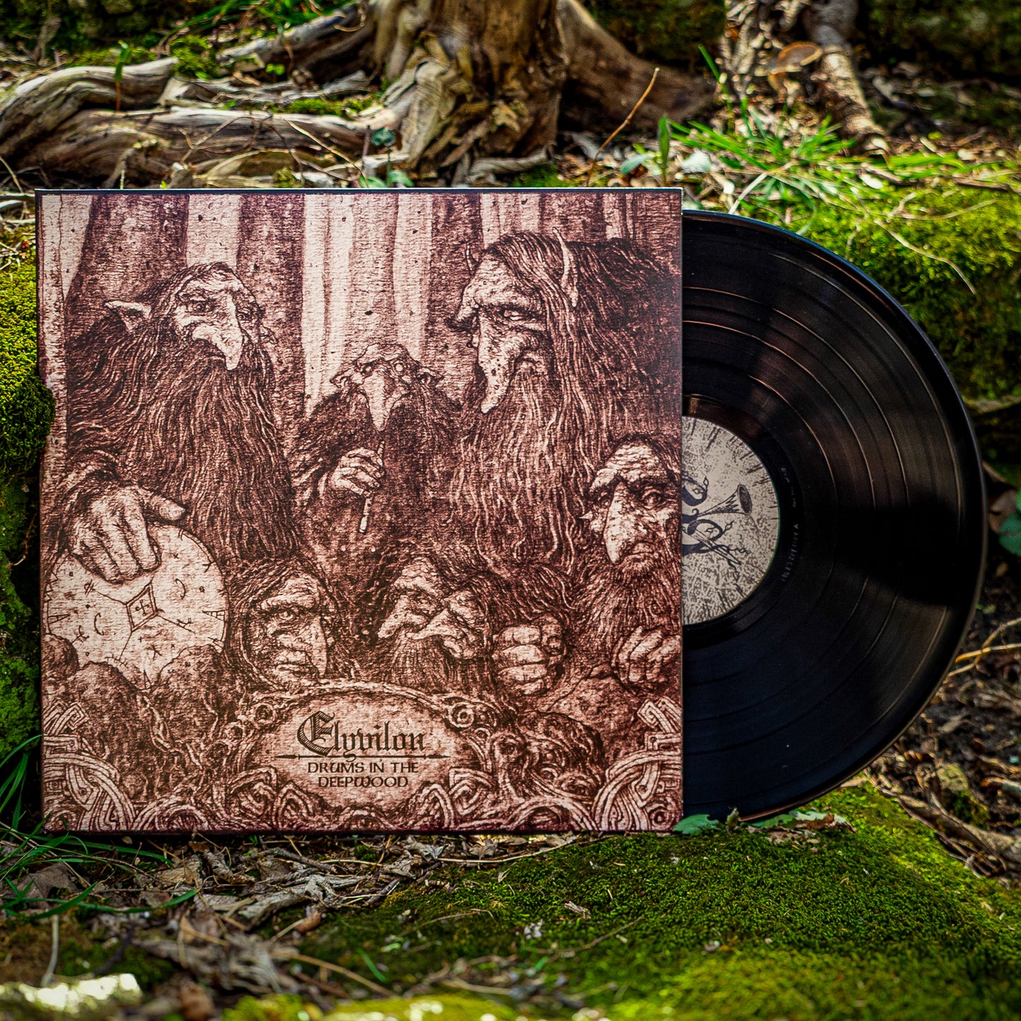 Vinyl record with cover featuring engraved images of dwarves on a natural background. The vinyl is black and perched on a bed of moss.
