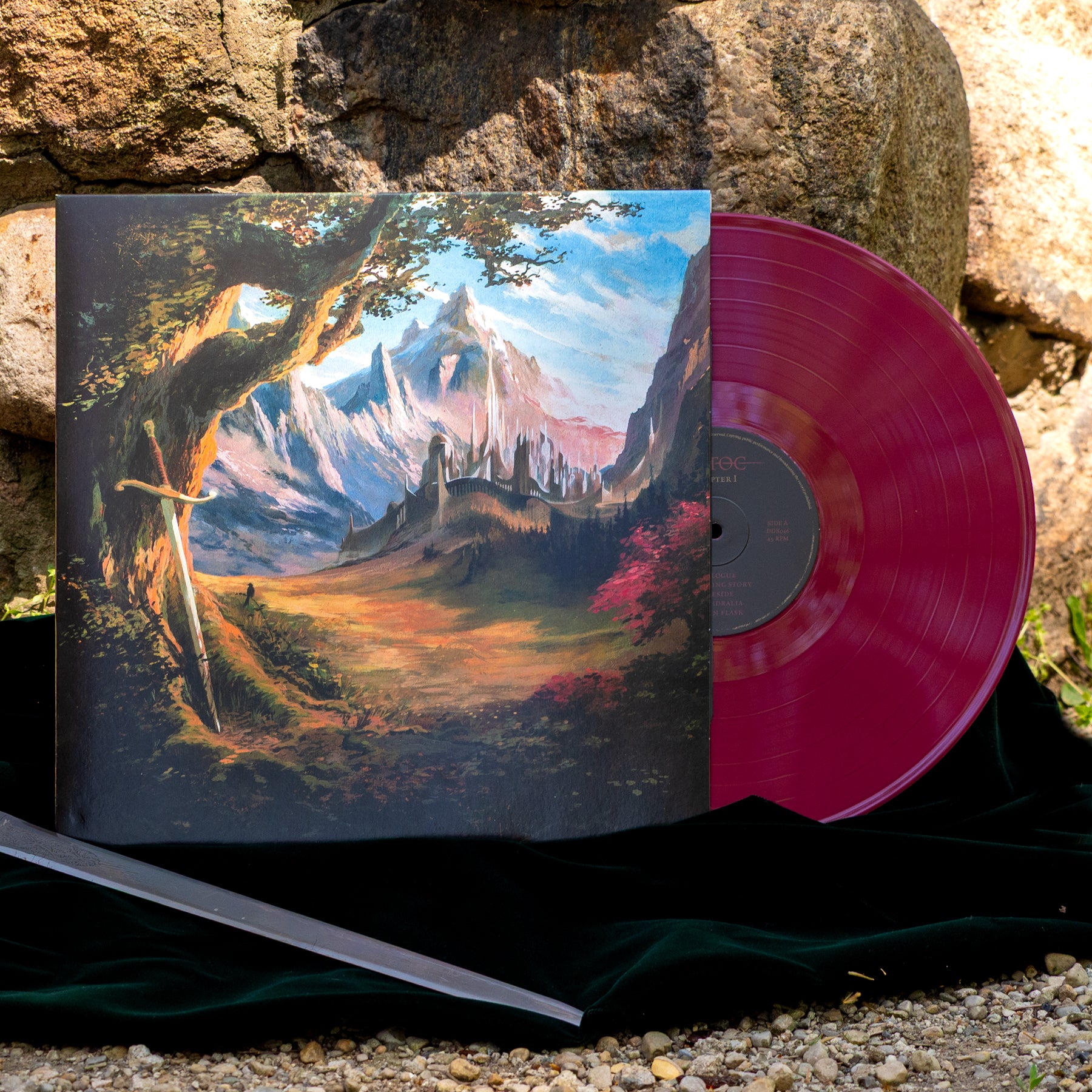 Vinyl record of Estoc's Chapter I Burgundry vinyl. The album artwork depicts a colorful mountain landscape. The record rests against a stone wall.