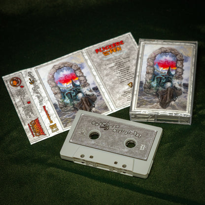 Flickers From the Fen - Stoned in Gielinor II cassette tape album sits on a green velvet background. The cassette tape is grey in color. The album cover shows an image of a wizard emerging from a portal, conjuring a spell.