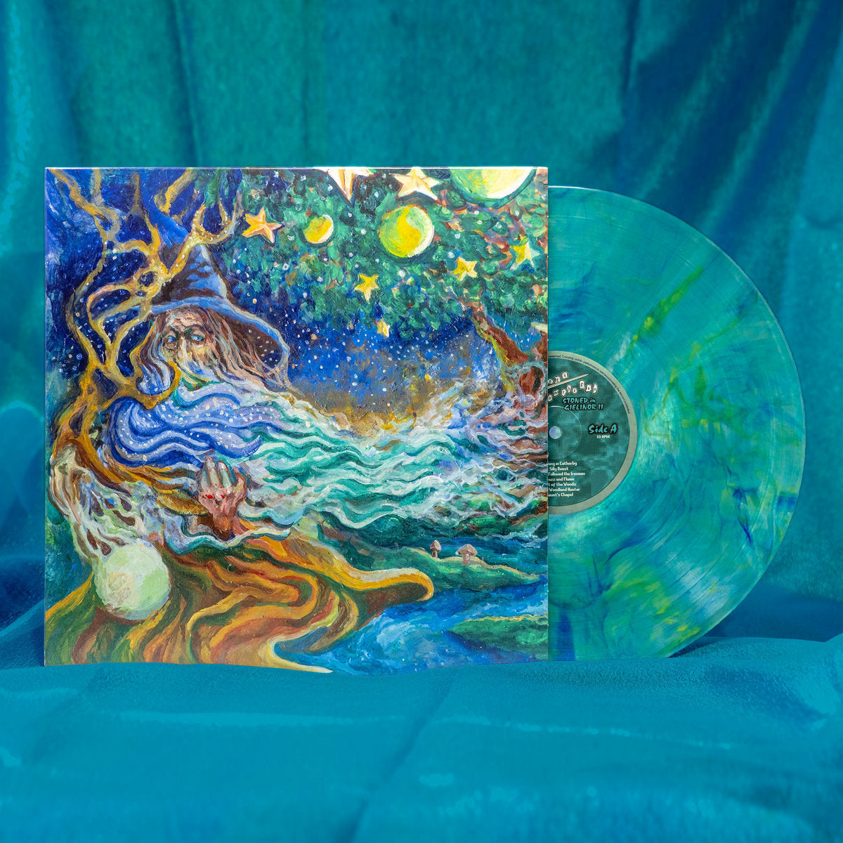 A colorful blue and green vinyl record of Flickers From the Fen Stoned in Gielinor II rests against a blue velvet backdrop.