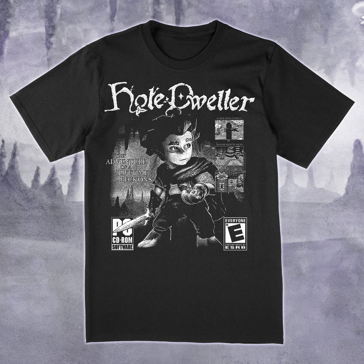 A black short-sleeve graphic t-shirt featuring a stylized print of the character Hyle Dweller with game-style rating logos, shown against a moody gray fantasy landscape background.