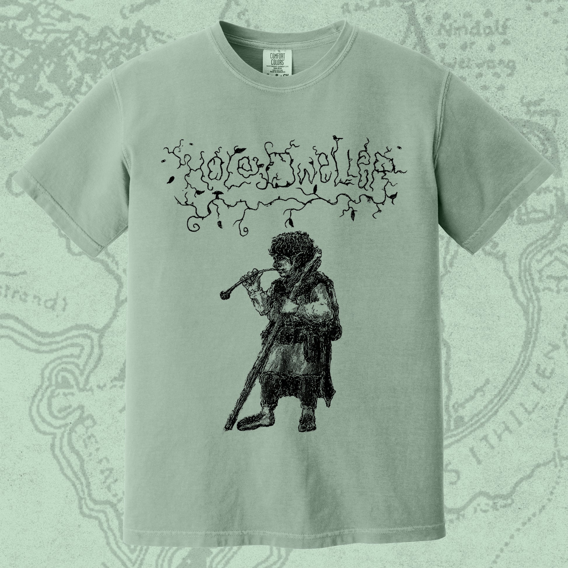 Hole Dweller "flies the coop I" T-Shirt printed in black ink on a light green shirt. The graphic shows the Hole Dweller logo, and a hobbit smoking a pipe.