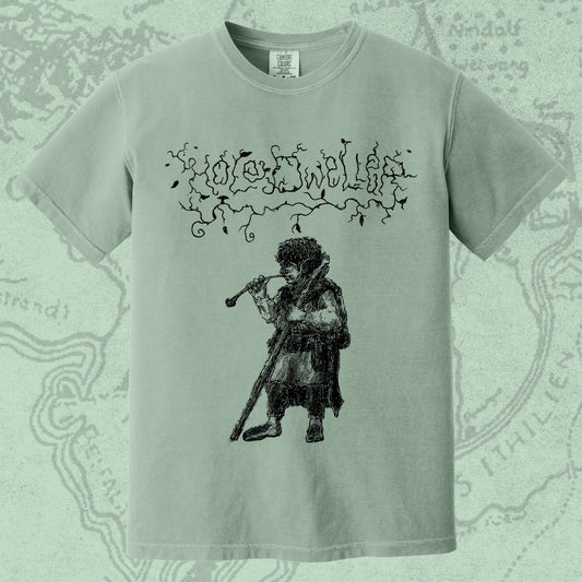 Hole Dweller "flies the coop I" T-Shirt printed in black ink on a light green shirt. The graphic shows the Hole Dweller logo, and a hobbit smoking a pipe.