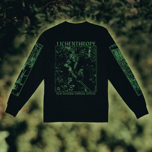 Black long-sleeve t-shirt with green graphic prints on the back and sleeves, featuring the text 'LICHENTHROPE' and 'OLD SCHOOL FUNGAL SYNTH', displayed against a blurred forest background.
