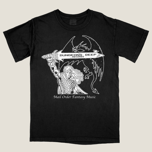 Black Comfort Colors t-shirt with 'Mail Order Fantasy Music' text and illustrations screen printed on the front. The design depicts a man holding a sword with the words "Dungeons Deep Records" inscribed next to a fantasy dragon.