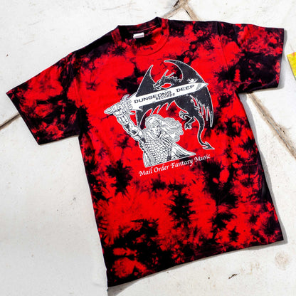 A black and red  tie dye shirt featuring 'Mail Order Fantasy Music' text and illustrations screen printed on the front. The design depicts a man holding a sword with the words "Dungeons Deep Records" inscribed next to a fantasy dragon.
