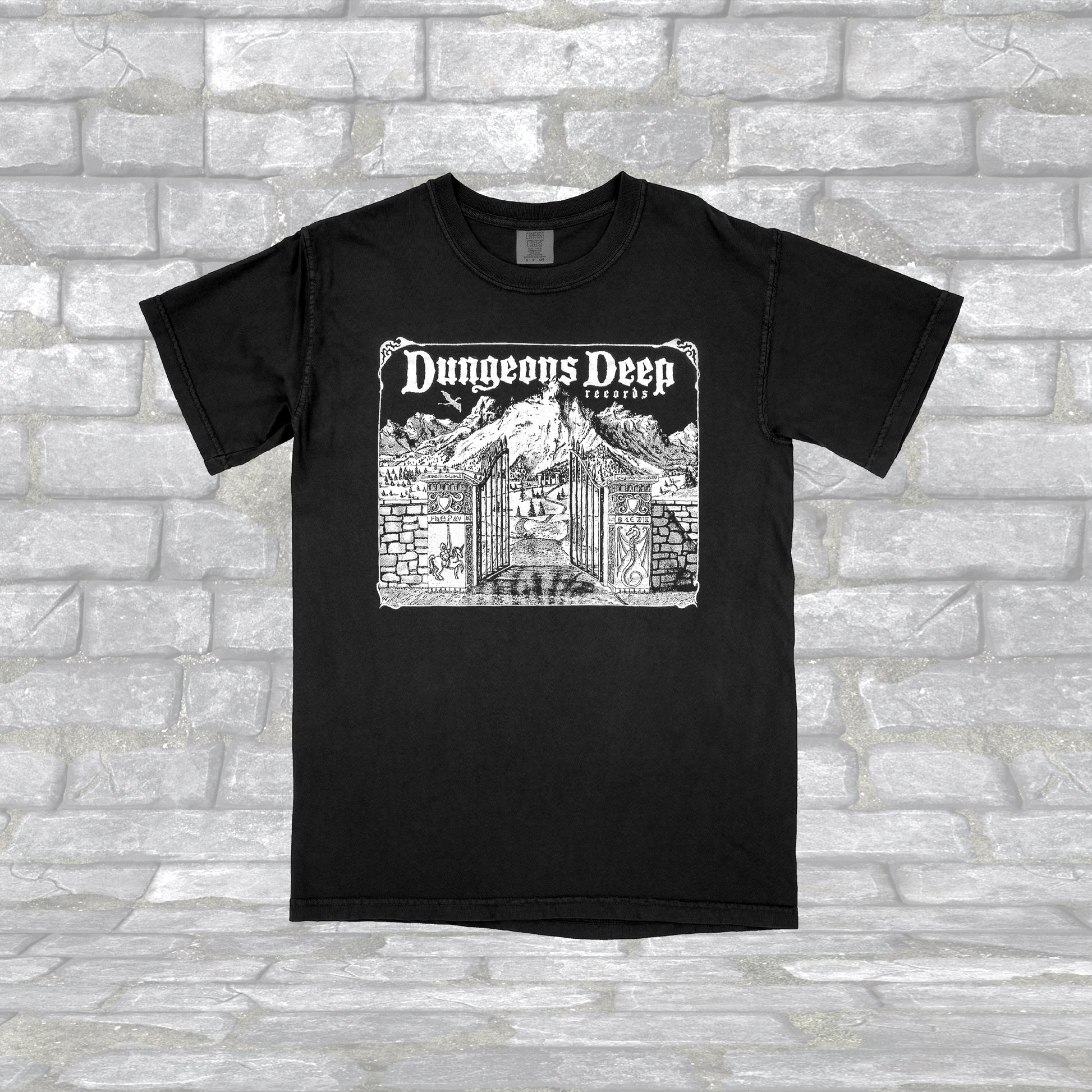 Black T-shirt with 'Dungeons Deep Records' text and a graphic of a a mystical landscape on the front.