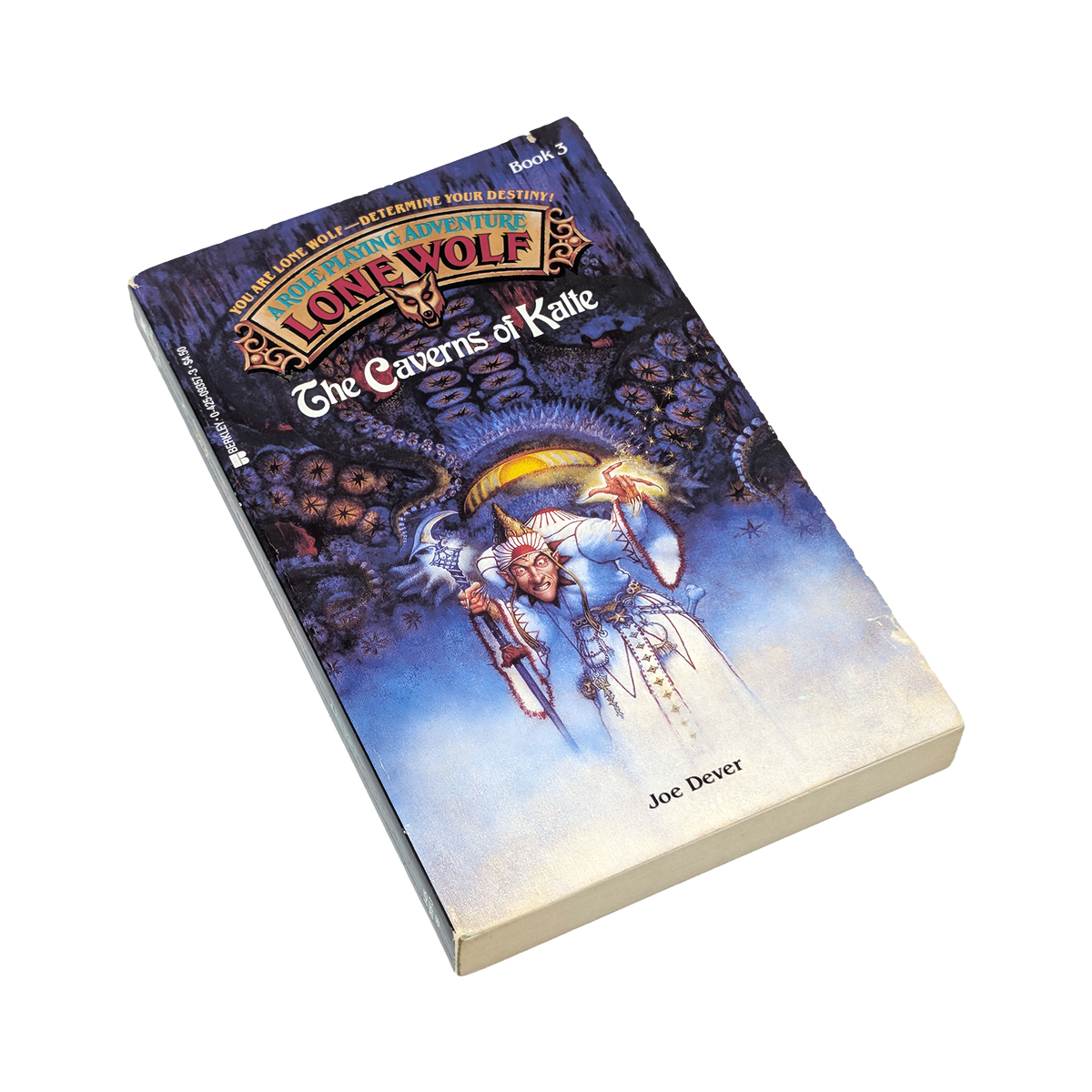 A single paperback book titled "The Caverns of Kalle" from the "Lone Wolf" series by Joe Dover, shown at an angle on a plain white background. The cover features fantasy artwork with a blue and purple cosmic background and a central figure in white robes.