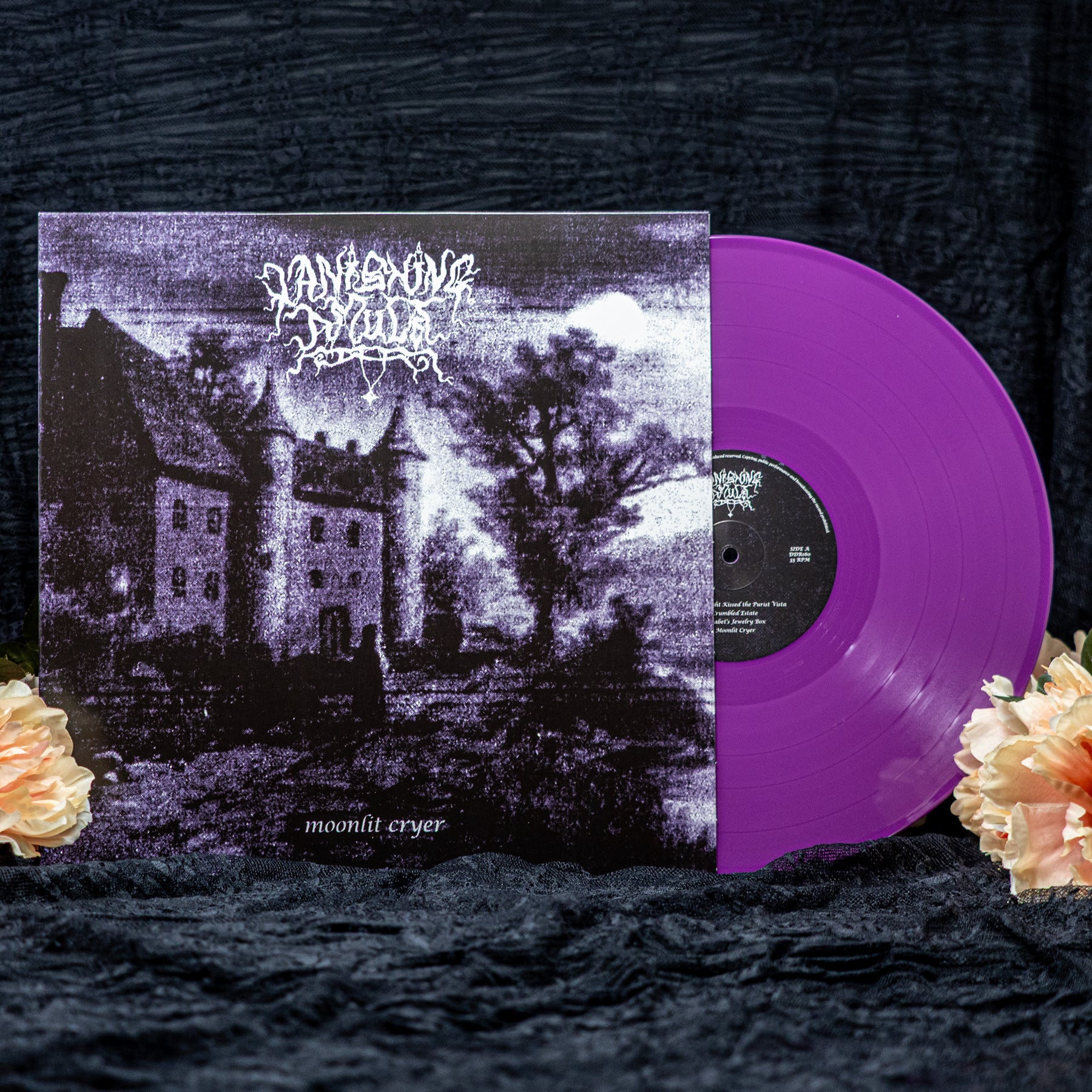 Vanishing Amulet "Moonlit Cryer" Purple vinyl record in standard purple. The cover shows a lonely man in front of a castle at night. Set against a black backdrop with flowers.